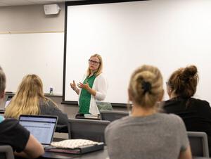 Social Work Program Director Toni Jensen in the front of a classroom teaching.